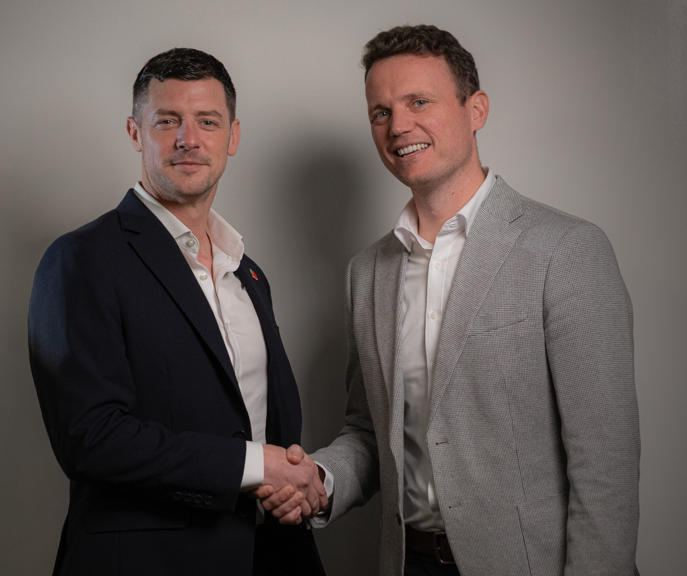 PJ Farr (Executive Chairman) & Joe Budnar-Hunt (CEO) shaking hands.