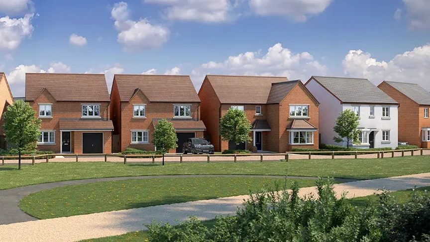 Row of newly built family homes overlooking a green open space under a blue sky.