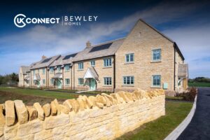 Row of newly built Bewley Homes properties with solar panels and landscaped grounds, featuring UK Connect and Bewley Homes branding.